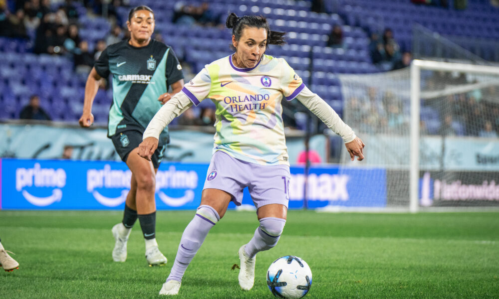 Image of Marta playing the ball against Jess Carter of Gotham FC