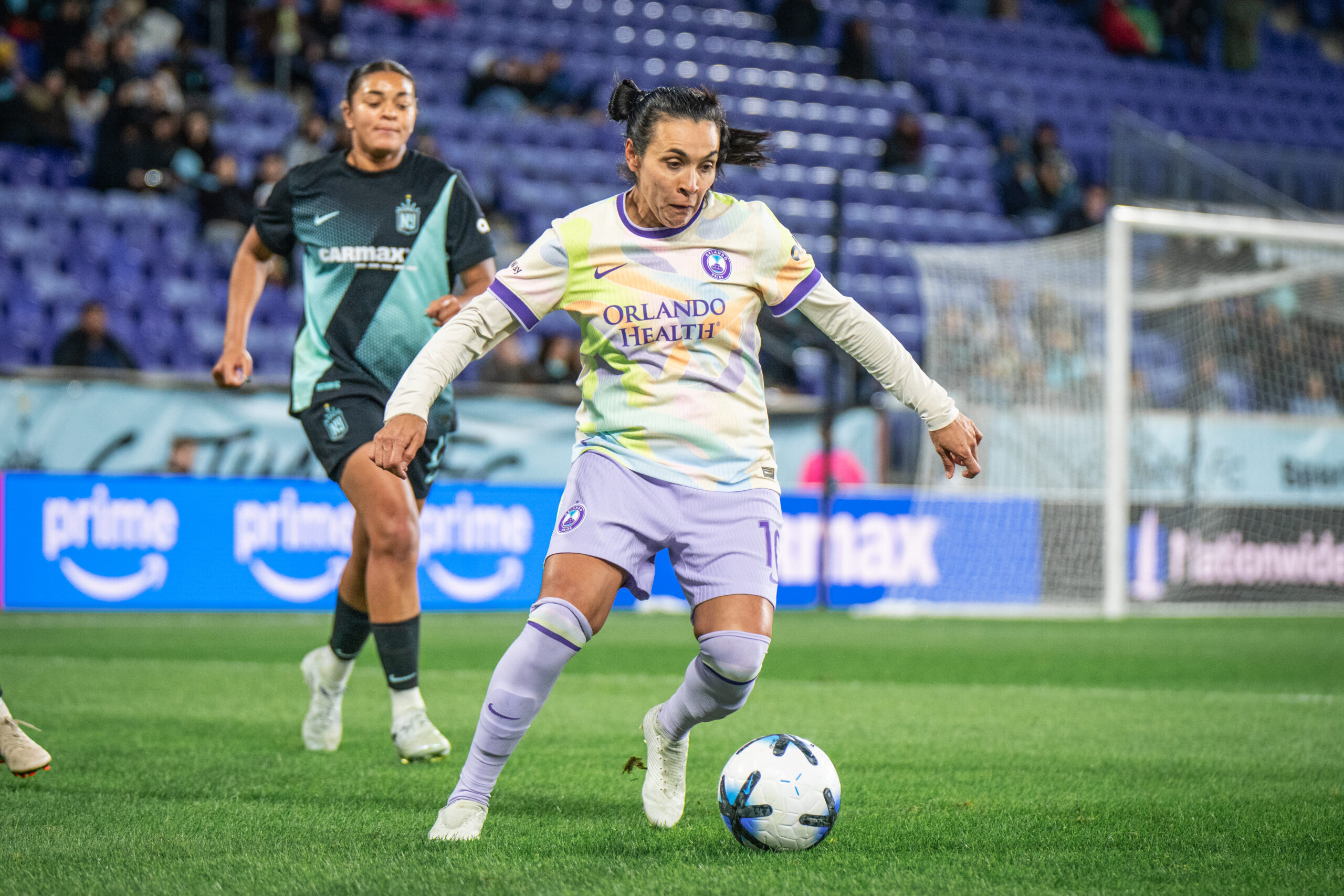 Image of Marta playing the ball against Jess Carter of Gotham FC