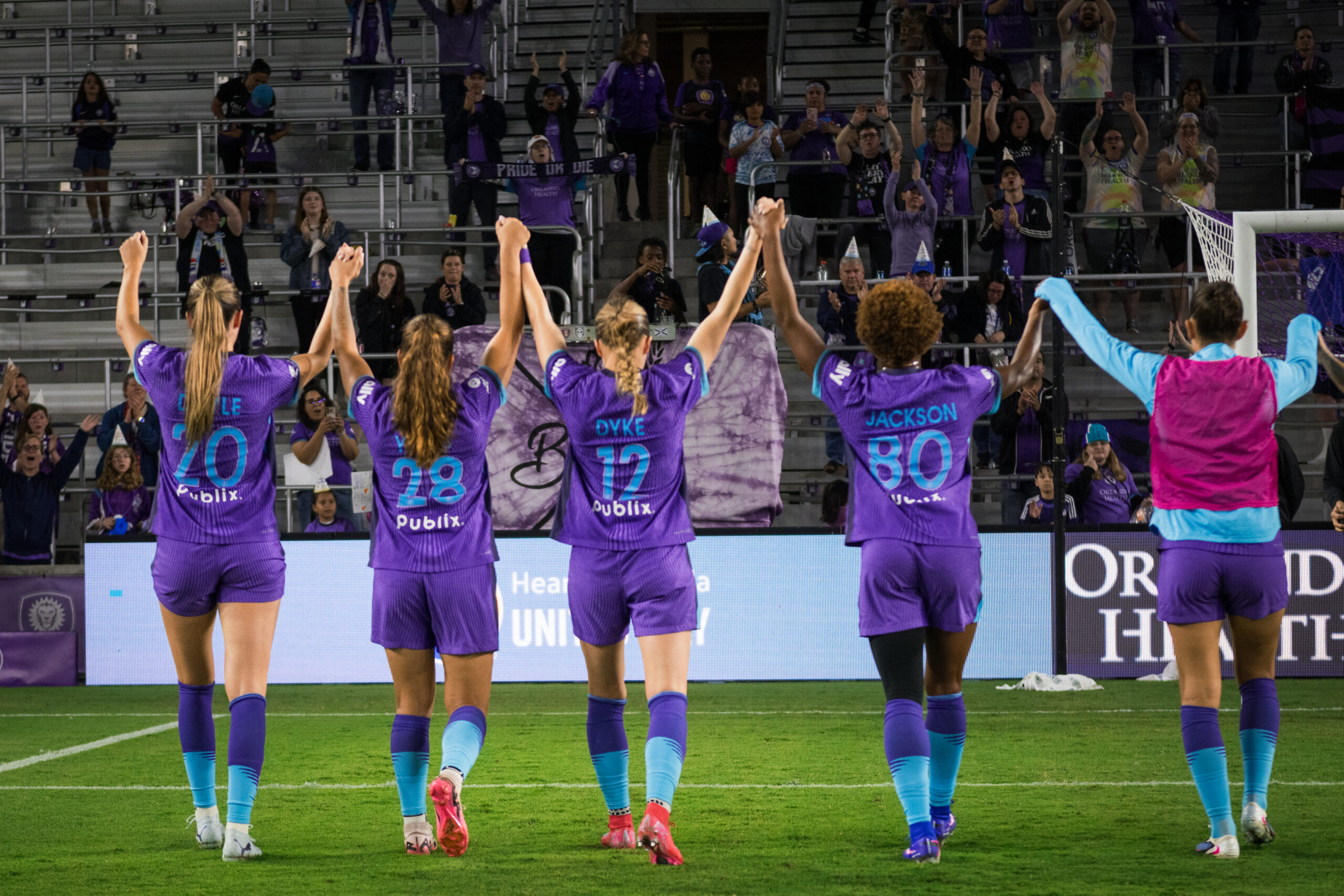 Image of Pride players celebrating with fans.