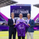 Image of Antoine Griezmann posing with his Orlando City kit alongside Ricardo Moreira and Mark Wilf.