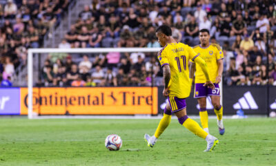 Image of TIago playing the ball with Iago looking on in the background.