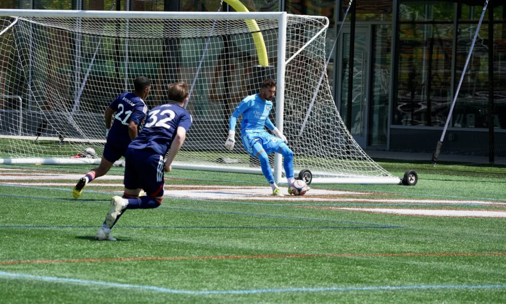 Image of Luca Maxim playing the ball for OCB against New England Revolution II.
