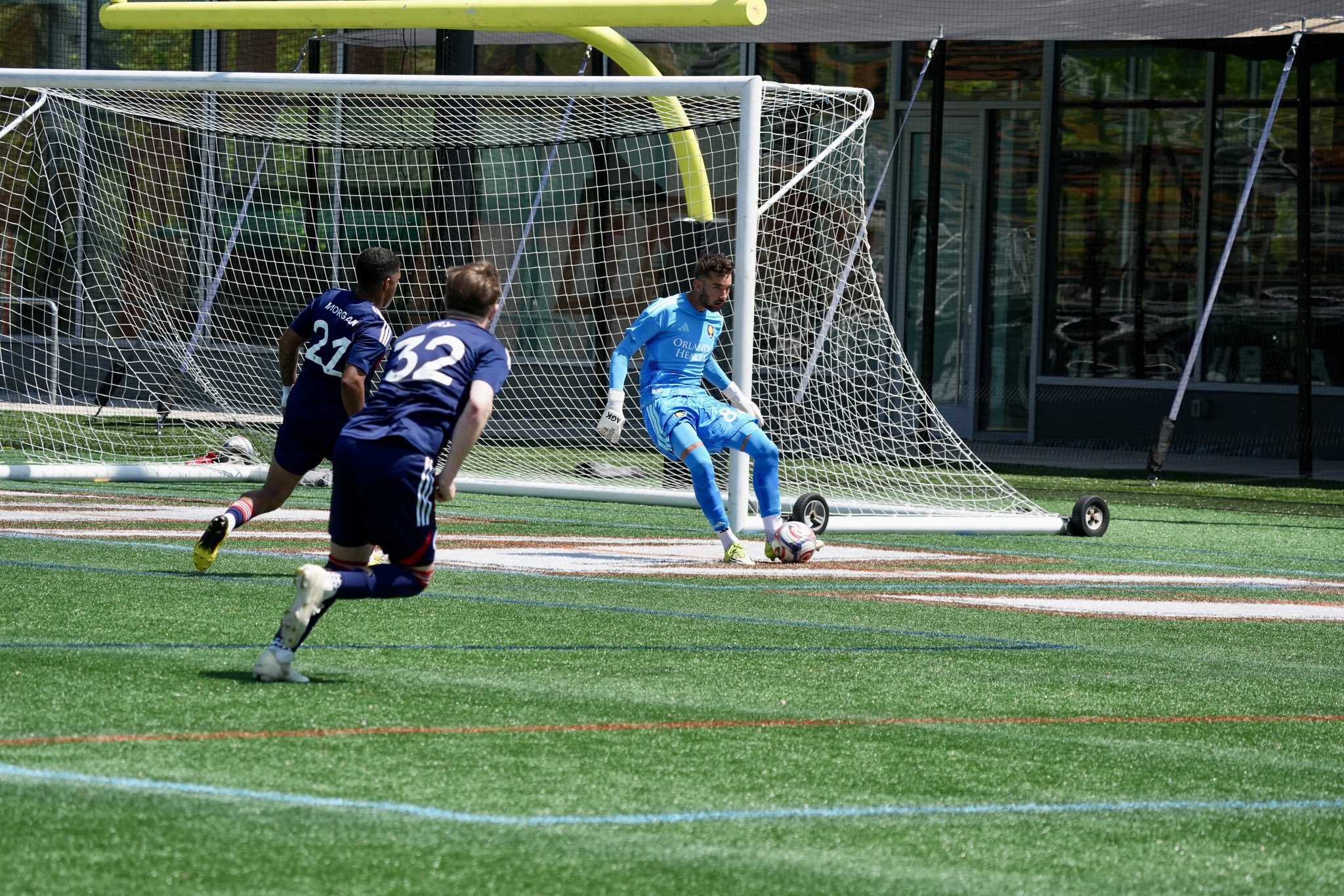 Image of Luca Maxim playing the ball for OCB against New England Revolution II.