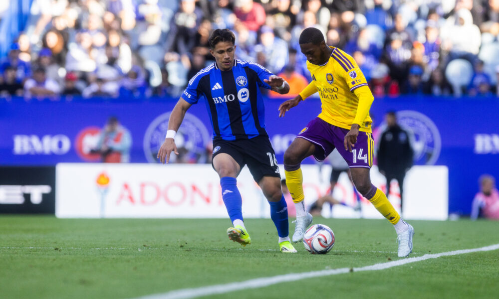 Image of Tyrese Spicer trying to dribble past a Montreal player.