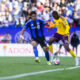 Image of Tyrese Spicer trying to dribble past a Montreal player.