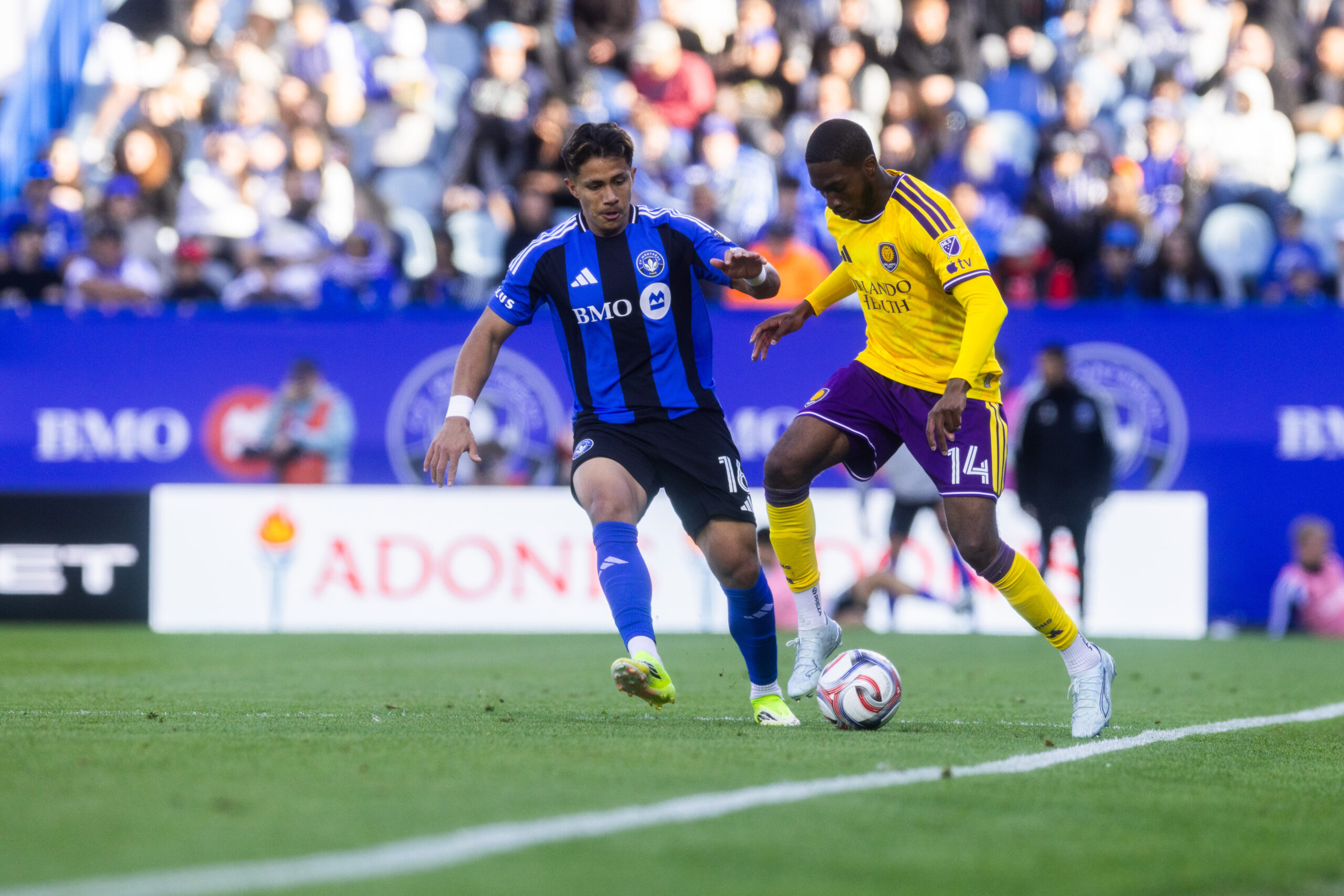Image of Tyrese Spicer trying to dribble past a Montreal player.