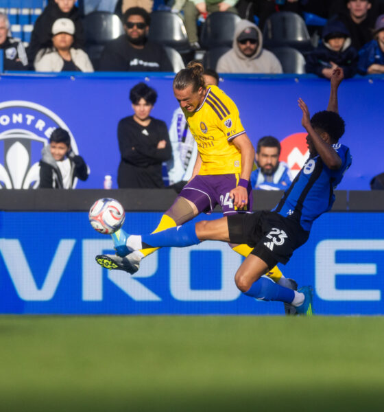 Image of Griffin Dorsey trying to send the ball upfield against a Montreal defender.