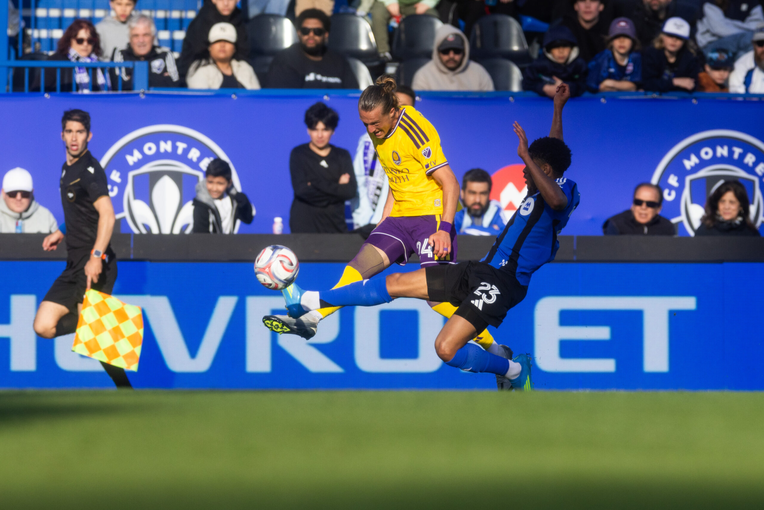 Image of Griffin Dorsey trying to send the ball upfield against a Montreal defender.