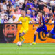 Image of Griffin Dorsey dribbling up the side past two FC Cincinnati defenders.