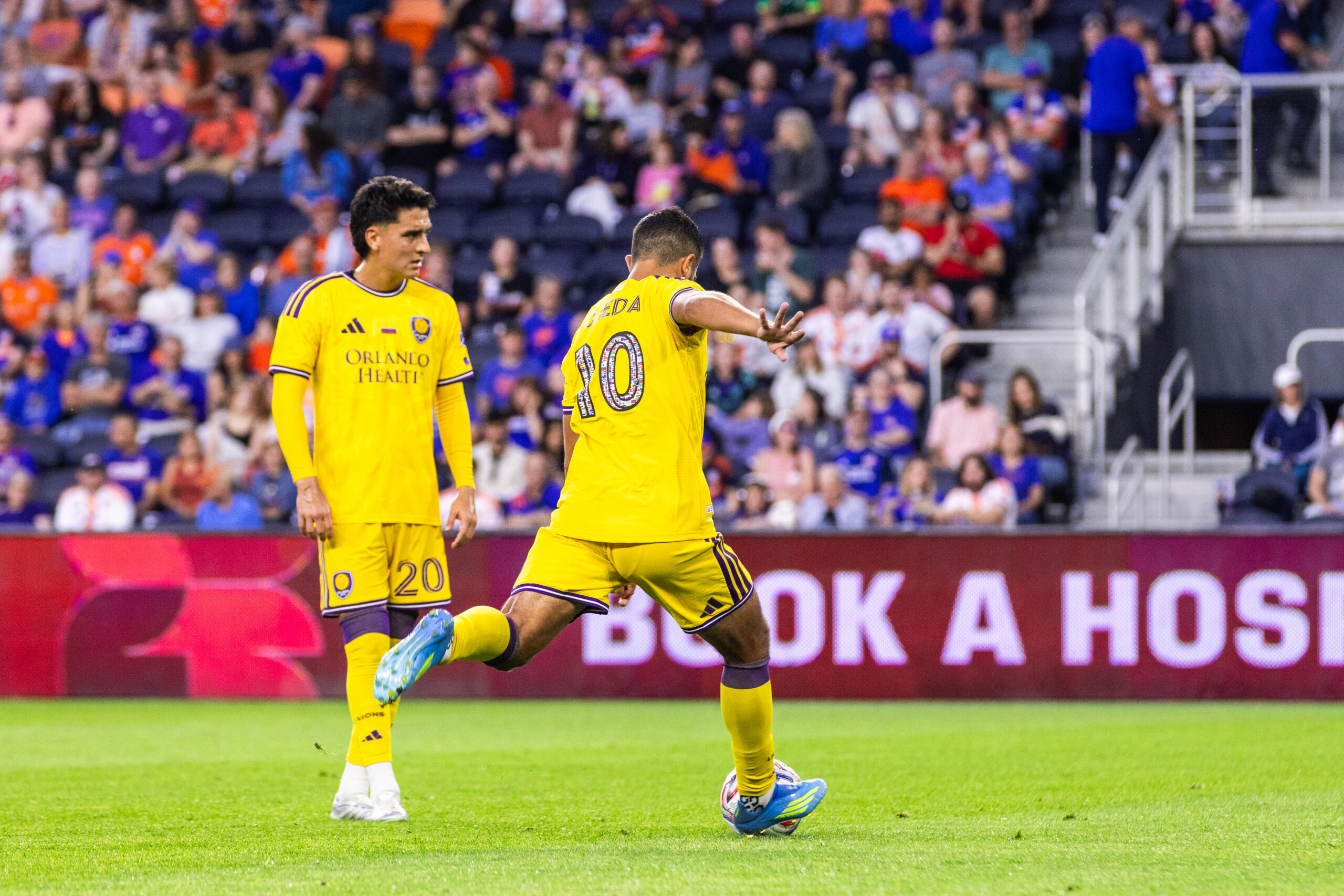 Image of Martin Ojeda taking a free kick against FC Cincinnati as Eduard Atuesta looks on.