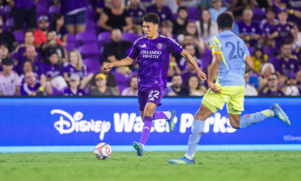 Image of Justin Ellis dribbling the ball trying to beat a Philadelphia Union defender.
