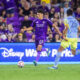 Image of Justin Ellis dribbling the ball trying to beat a Philadelphia Union defender.