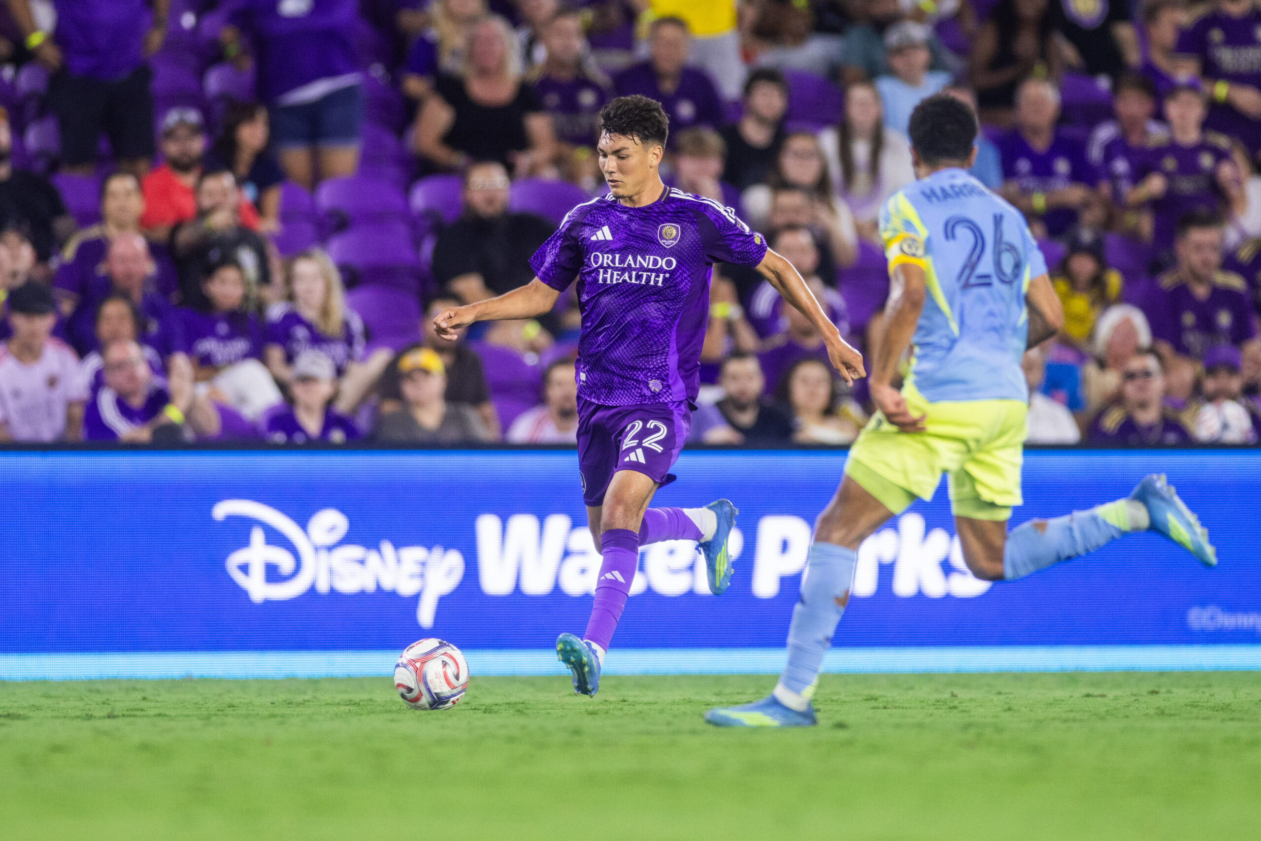 Image of Justin Ellis dribbling the ball trying to beat a Philadelphia Union defender.