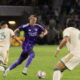Image of Griffin Dorsey trying to find space against two Atlanta defenders.