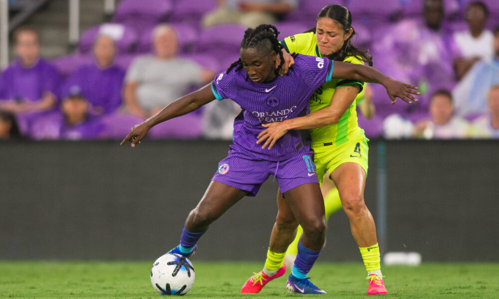 Image of Barbra Banda holding off a Washington Spirit defender.