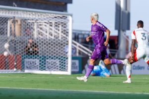 Image of Antoine Griezmann watching his shot go in the net against FC Dallas in a friendly.