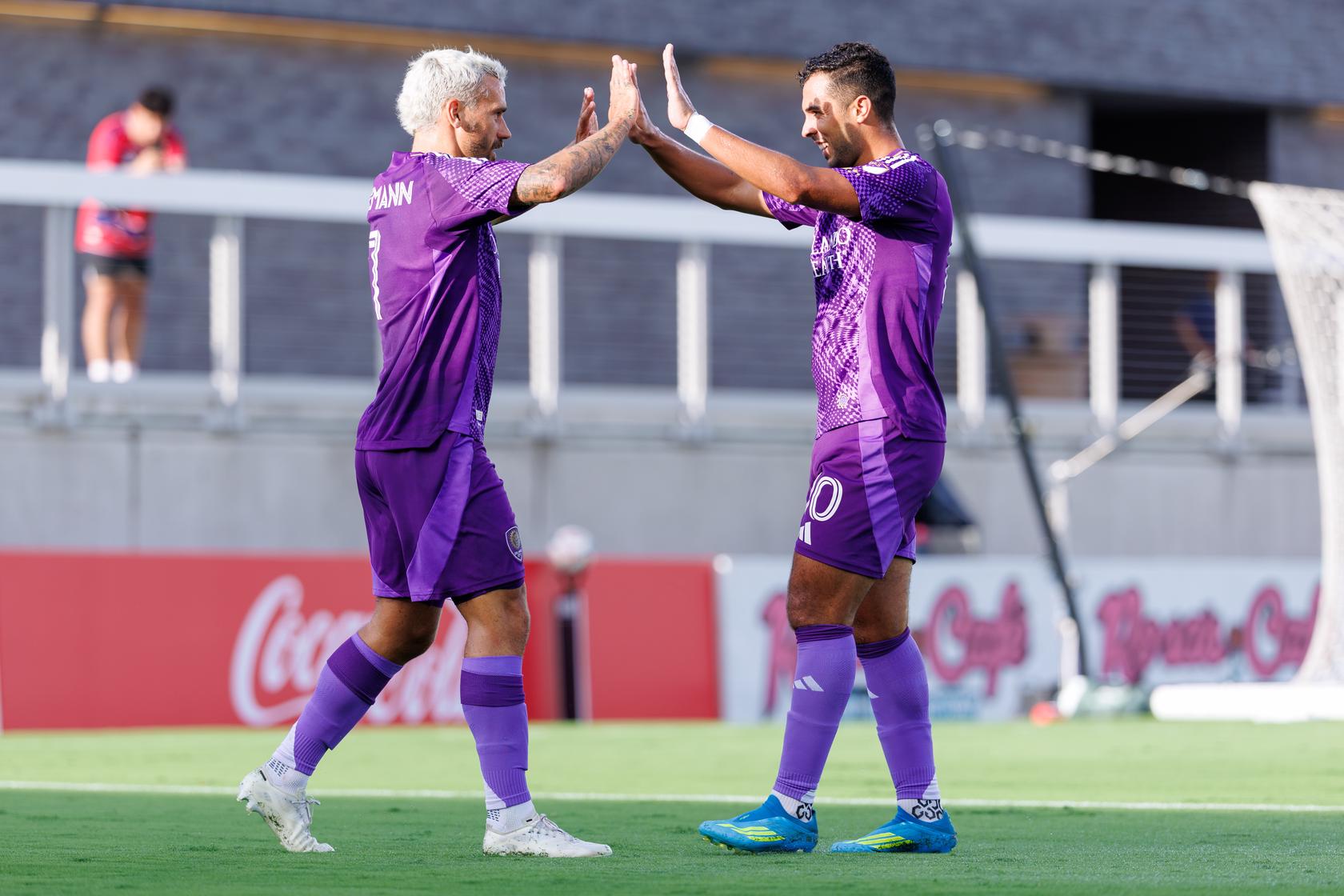 Image of Antoine Griezmann and Martin Ojeda celebrating a goal during Orlando City's 2-1 friendly win at FC Dallas.