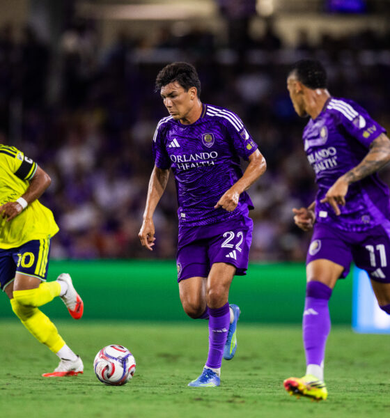 Image of Justin Ellis dribbling the ball with Tiago to his left and Nashville's Hany Mukhtar defending to his right.
