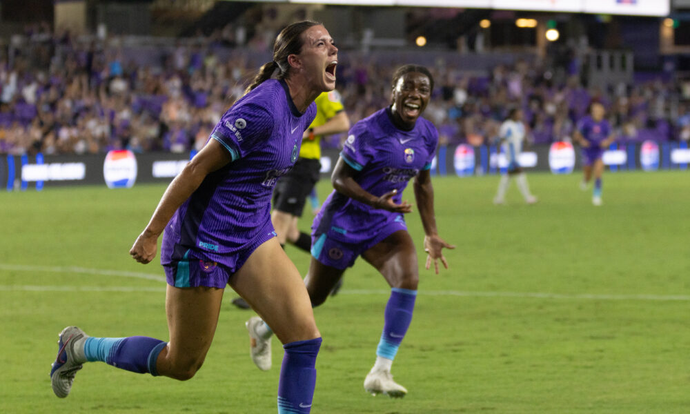Image of Julie Doyle celebrating her winning goal against Chicago as Nicole Payne cheers her on.