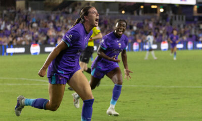 Image of Julie Doyle celebrating her winning goal against Chicago as Nicole Payne cheers her on.