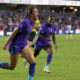 Image of Julie Doyle celebrating her winning goal against Chicago as Nicole Payne cheers her on.