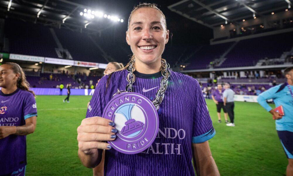 Image of Hannah Anderson posing with her Pride Player of the Match chain.