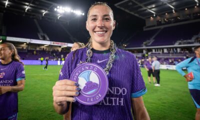 Image of Hannah Anderson posing with her Pride Player of the Match chain.