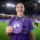 Image of Hannah Anderson posing with her Pride Player of the Match chain.