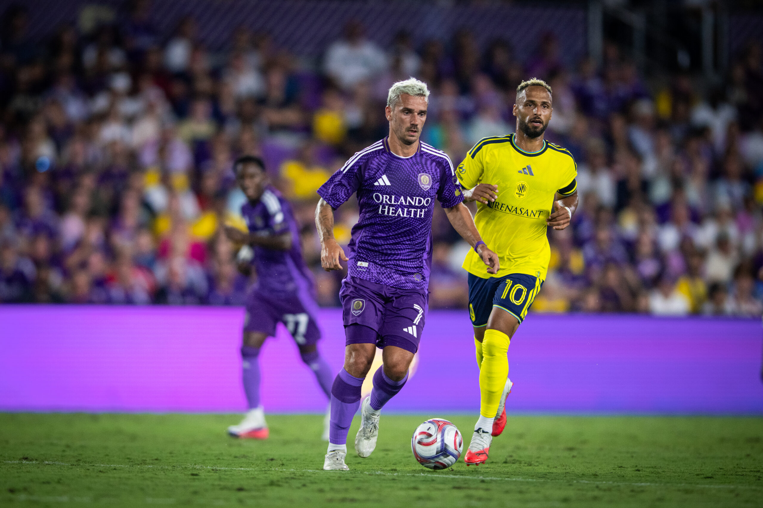 Image of Antoine Griezmann dribbling the ball past Hany Mukhtar of Nashville.