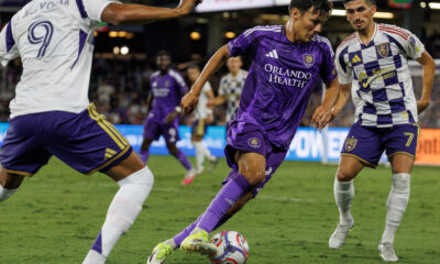 Image of Justin Ellis slicing between two Real Salt Lake defenders.