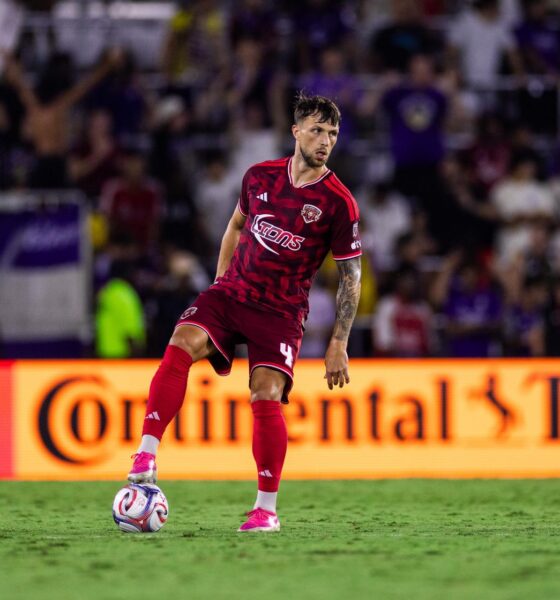Image of David Brekalo standing over the ball.