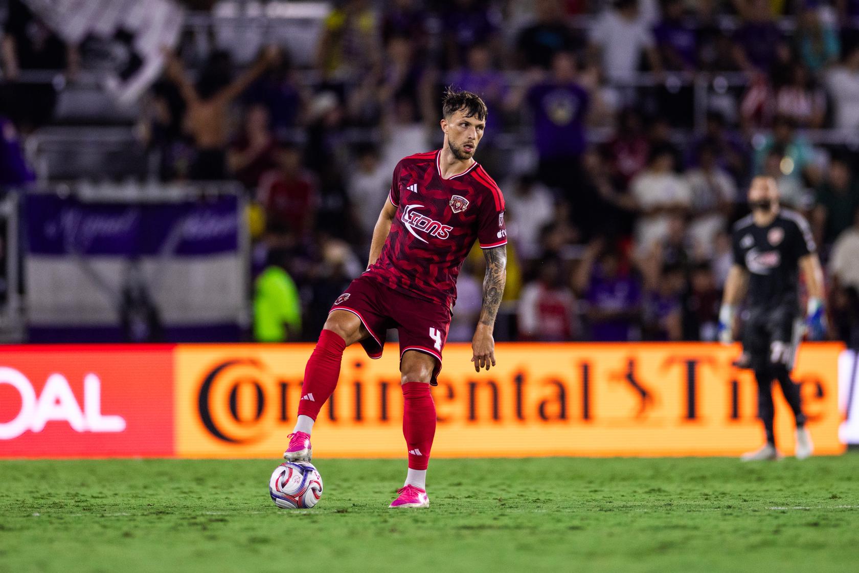Image of David Brekalo standing over the ball.