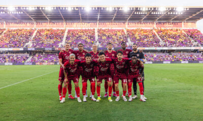 Image of Orlando City's starters pose for a pregame photo wearing their Archive Collection third kits.