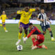 Image of Tyrese Spicer being fouled by Monterrey goalkeeper Luis Cardenas.