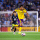 Image of Justin Ellis dribbling the ball upfield against Minnesota.