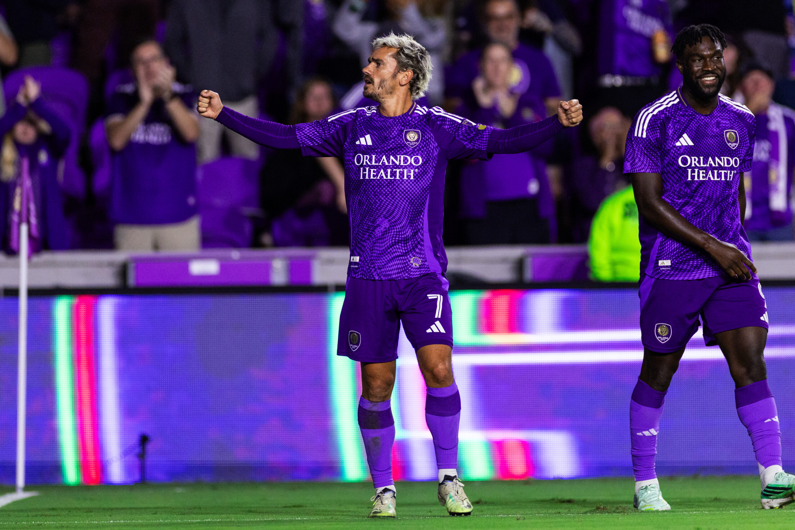 Image of Antoine Griezmann celebrating with fans and Daryl Dike.