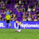 Image of Haley McCutcheon wearing a protective mask on her face playing against San Diego.