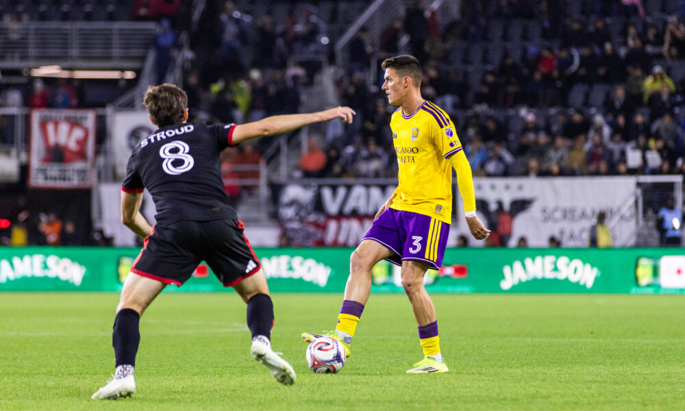 Image of Adrian Marin playing the ball as Jared Stroud of D.C. United defends.