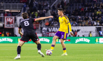 Image of Adrian Marin playing the ball as Jared Stroud of D.C. United defends.
