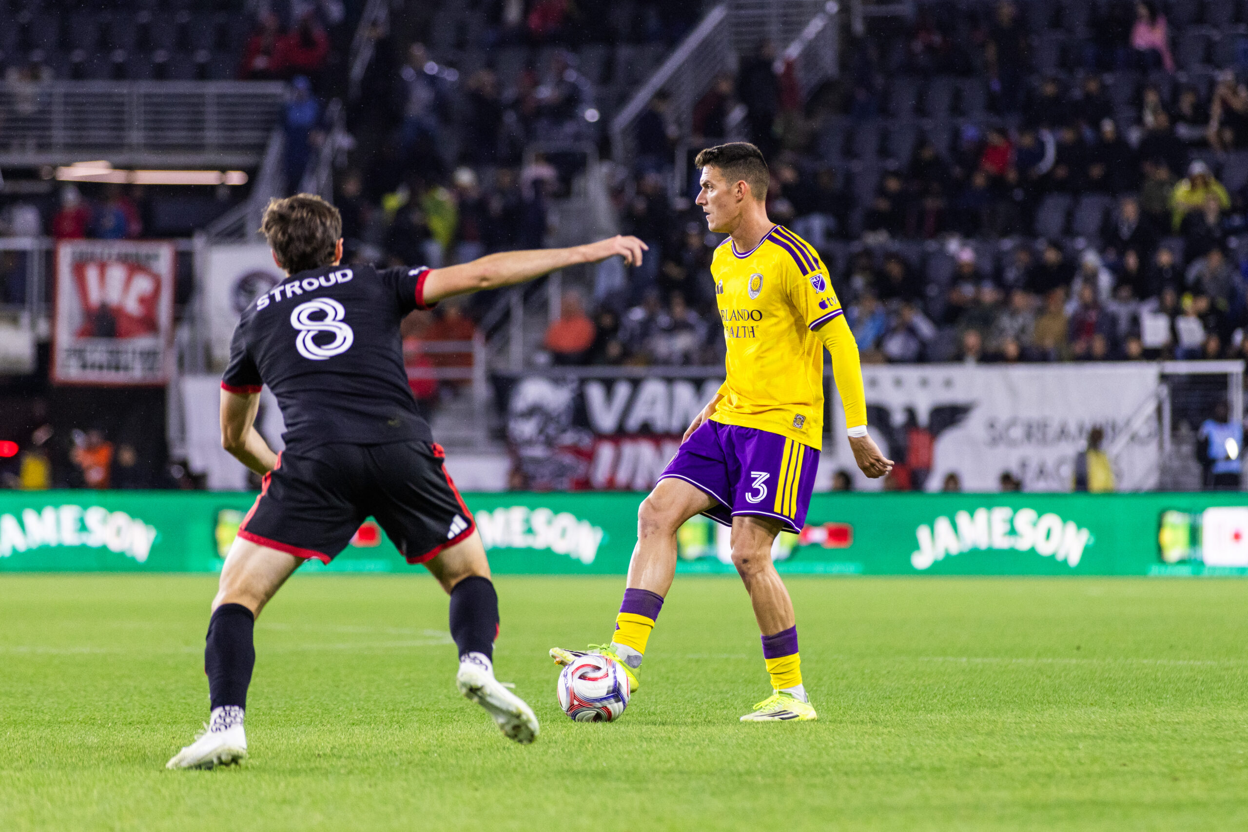 Image of Adrian Marin playing the ball as Jared Stroud of D.C. United defends.