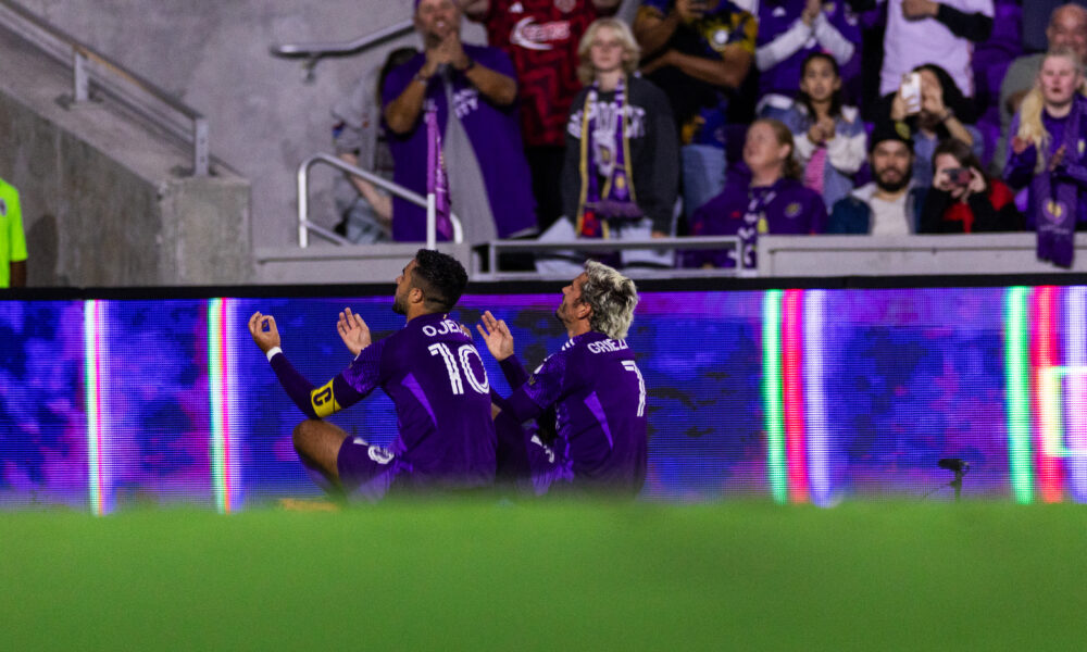 Image of Martin Ojeda and Antoine Griezmann celebrating a goal together.