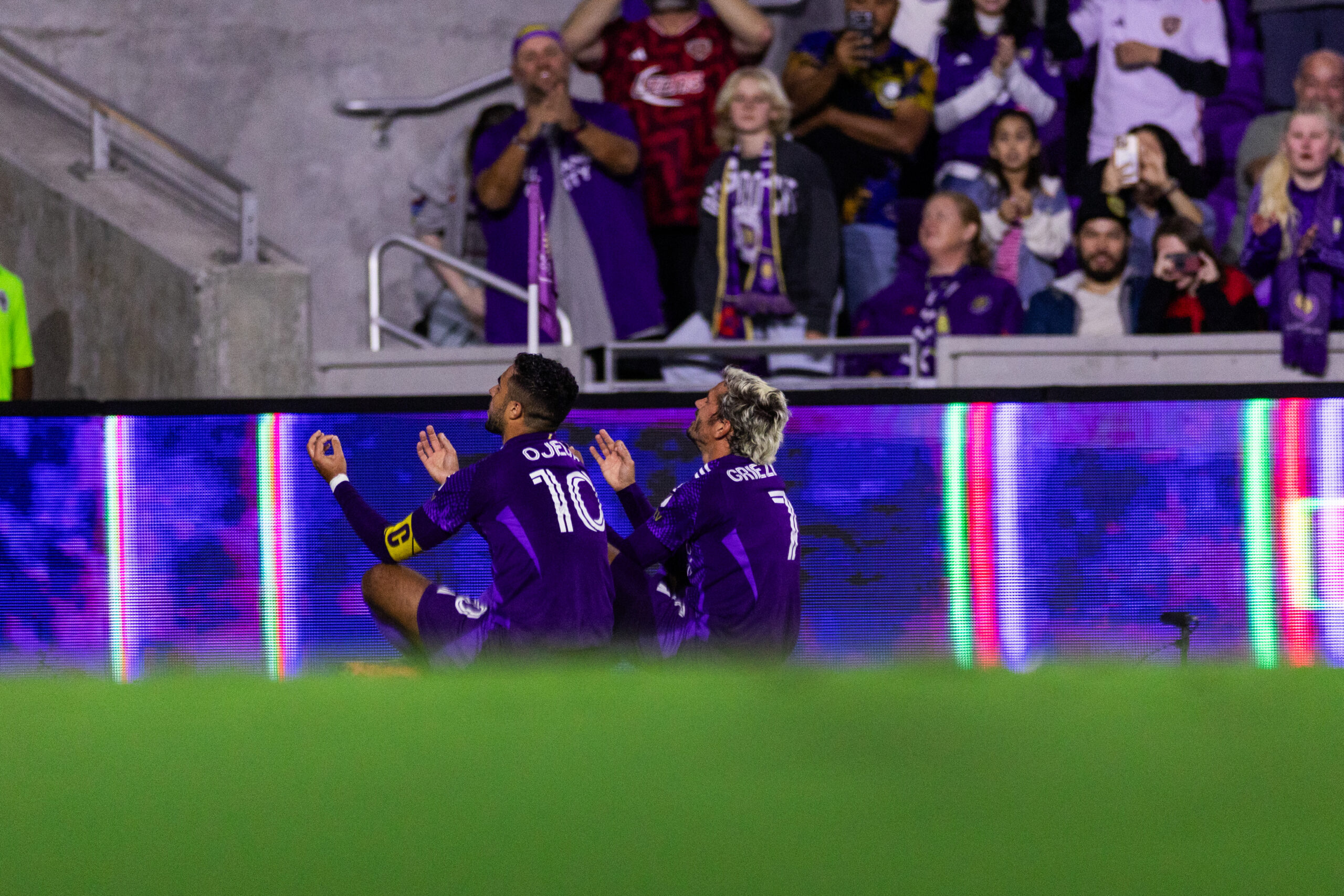 Image of Martin Ojeda and Antoine Griezmann celebrating a goal together.