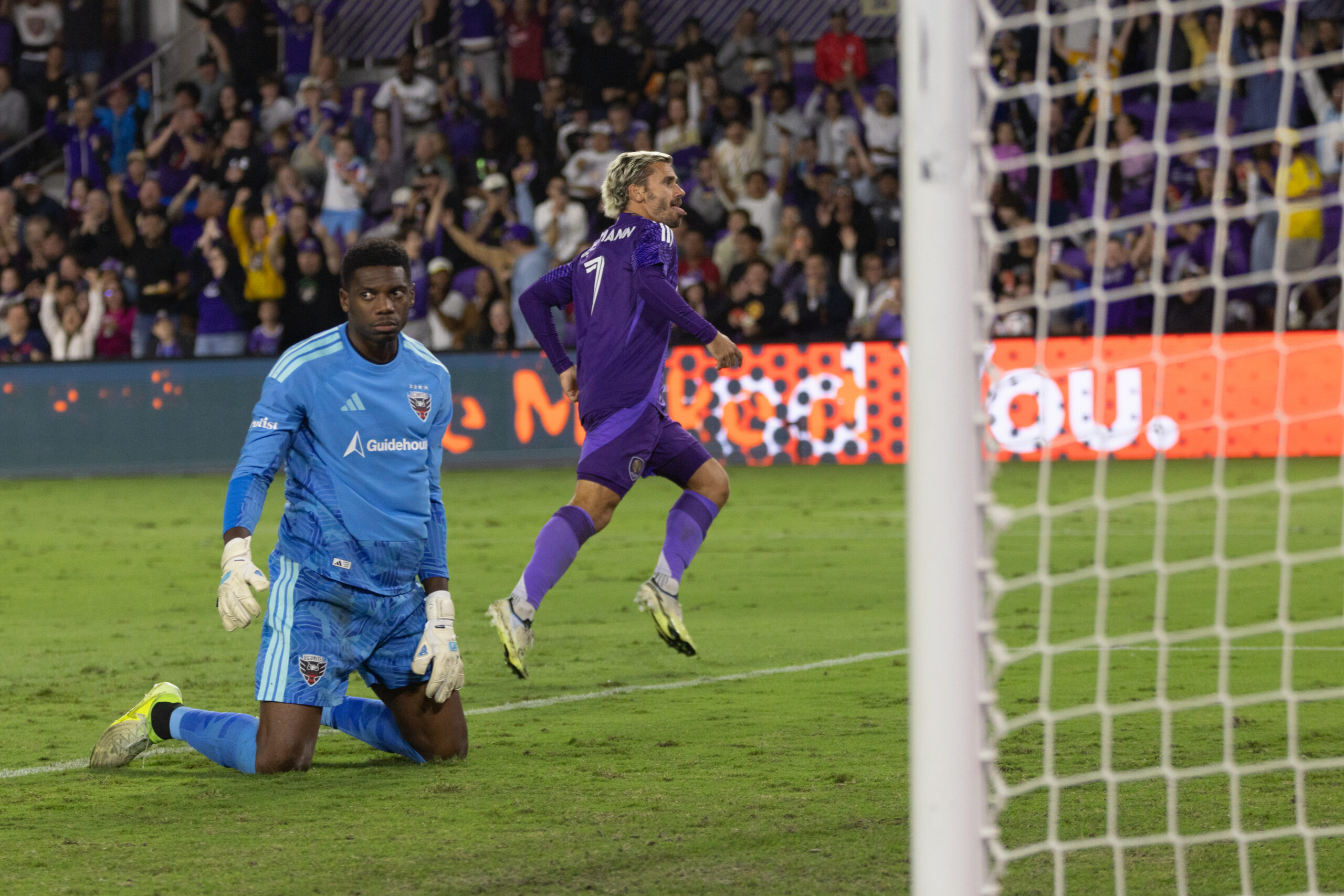 Image of Antoine Griezmann celebrating his goal against D.C. United as Sean Johnson reacts.